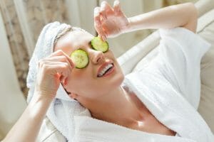 Woman relaxing with cucumber slices on eyes