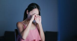Woman use of laptop computer and feeling dry of eye
