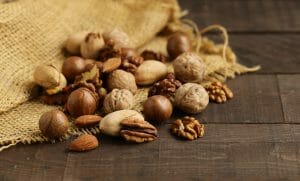 Nuts mix on wooden background, healthy food