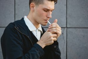 Fashion hipster male model smoking