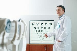 Ophthalmologist checking eyesight of patient