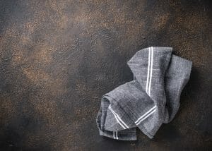 Gray linen napkin on rusty table